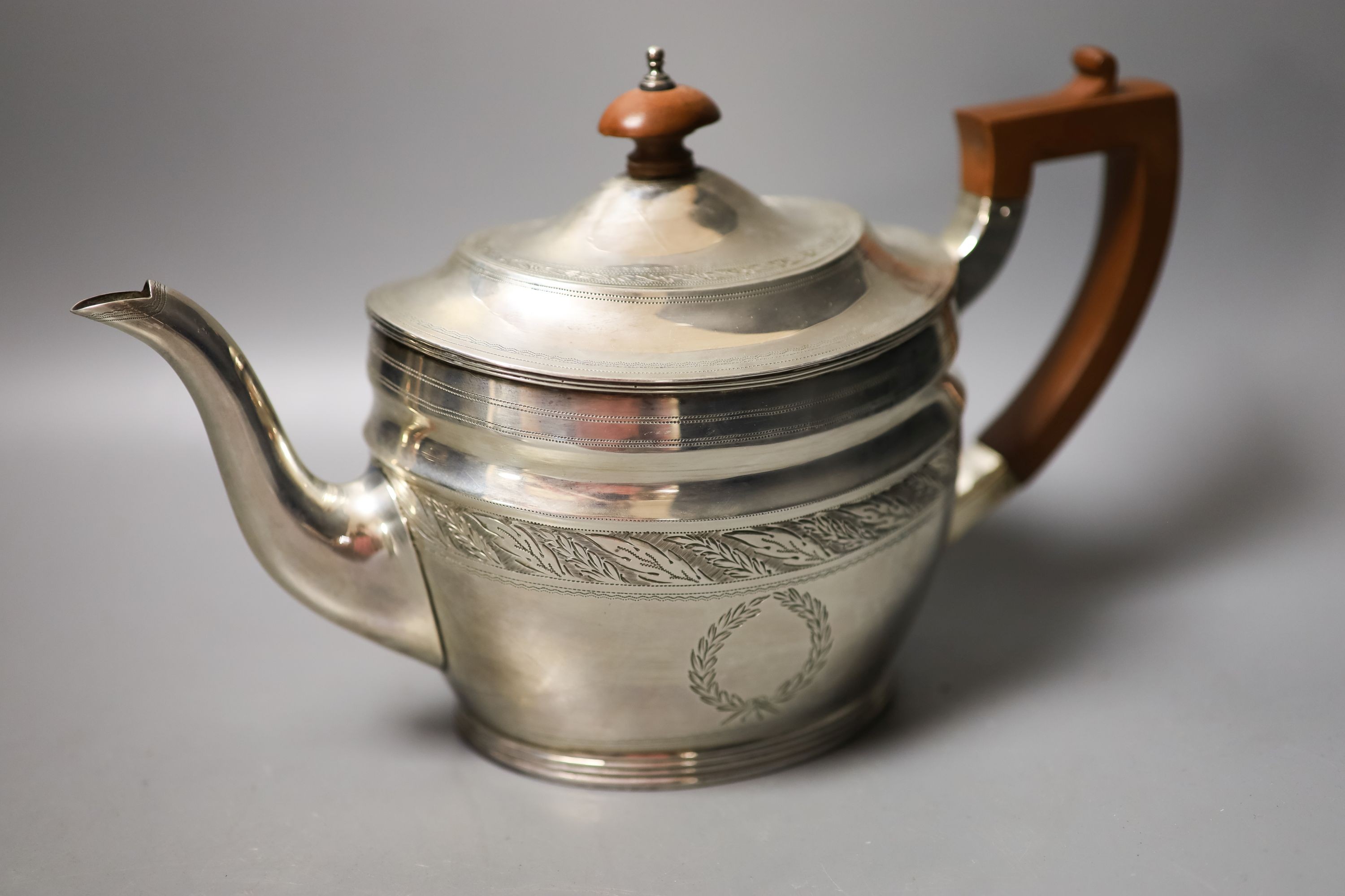 A George V three piece silver oval tea set, London, 1930, together with a similar George III silver cream jug, London, 1800